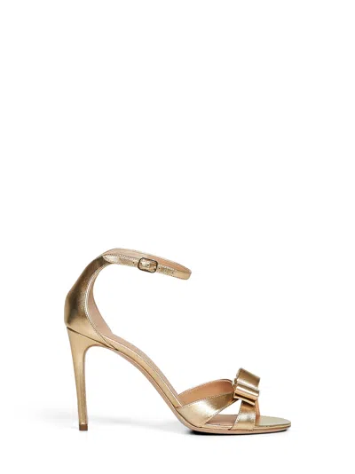 Ferragamo Gold Laminated Nappa Leather Roxy Vara Bow Sandals