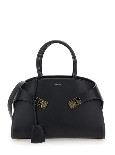 FERRAGAMO FERRAGAMO WOMEN 'HUG' BLACK HANDBAG WITH LOGO AND GANCINI BUCKLE IN LEATHER WOMAN