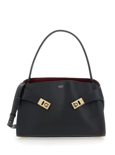FERRAGAMO FERRAGAMO WOMEN 'HUG' BLACK SHOULDER BAG WITH LOGO PRINT ON THE FRONT IN LEATHER WOMAN