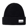 Ganni Wool-blend Ribbed-knit Beanie Hat In Black