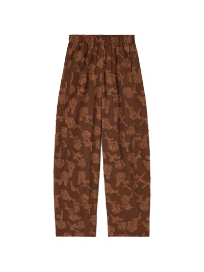 Ganni Fil-coupé Floral-pattern Trousers In Brown