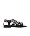 Ganni Buckle Sandals With Flat Sole And Metal Eyelets In Black