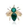 Genevive Jewelry Women's Gold / Green / White Emerald Cubic Zirconia Sterling Silver Gold Plated Bee Pin In Multi