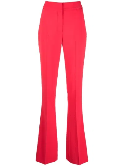 Genny Pressed-crease Flared Tailored Trousers In Orange