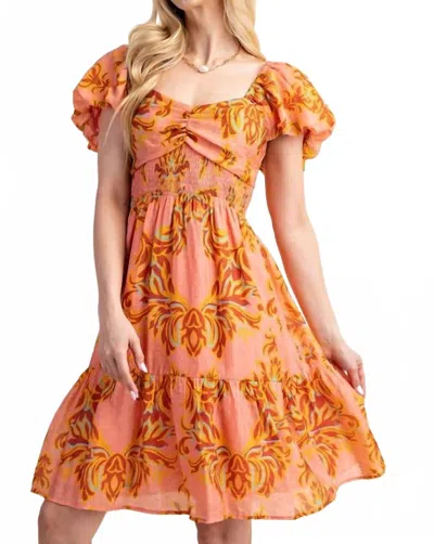 Gigio Smocked Babydoll Dress In Coral Multi In Orange