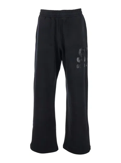GOLDEN GOOSE BLACK JOGGER PANTS WITH LOGO PRINTED ON THE SIDE IN COTTON MAN
