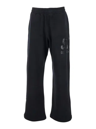GOLDEN GOOSE BLACK JOGGER PANTS WITH LOGO PRINTED ON THE SIDE IN COTTON MAN
