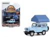 Greenlight 1969 Nissan Patrol (60) Light Blue With White Top And Camp'otel Cartop Sleeper Tent "the Great Outdo
