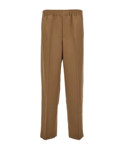 Gucci Appliqué-logo Cotton Tapered Trousers In Brown