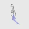 Gucci Engraved Dolphin Keychain Charm In Purple