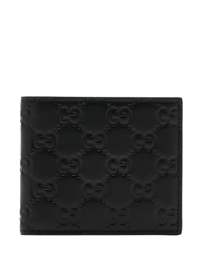 Gucci Men Gg Emblem Leather Wallet With Embossed Gg Logo In Black