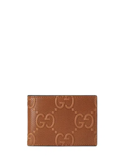 Gucci Gg Embossed Bi-fold Wallet In Brown