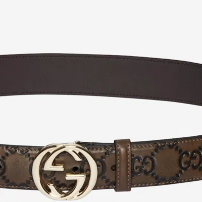 Gucci Gg Logo Embossed Leather Belt In Brown