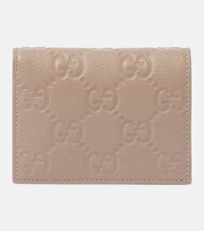 Gucci Gg Mini Debossed Leather Wallet In Beige