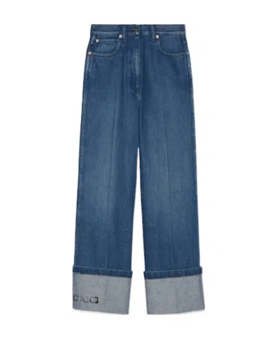 GUCCI GUCCI LOGO PRINTED WIDE-LEG JEANS