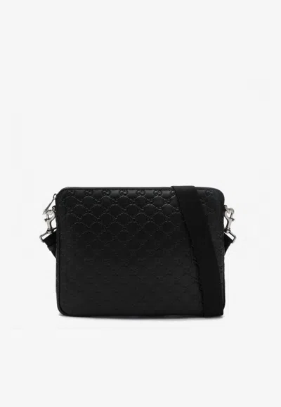 Gucci Medium Gg Embossed Leather Messenger Bag In Black
