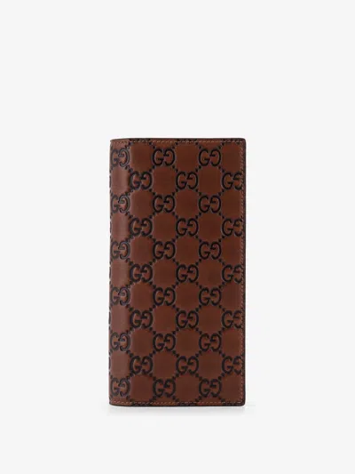 Gucci Men Gg Emblem Leather Wallet With Embossed Gg Motif In Brown
