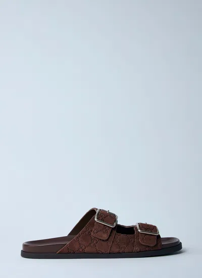 Gucci Men Logo Embossed Leather Slides In Brown
