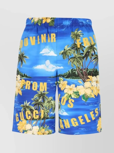 GUCCI WAISTBAND SWIM SHORTS WITH FLORAL AND GRAPHIC PRINTS