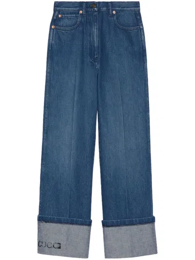 Gucci Wide-leg Denim Jeans With Leather Logo Tag And Roll-up Ankle Cuffs For Women