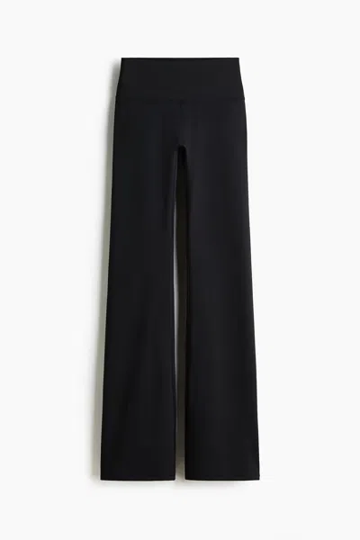 H&m Flared Yoga Leggings With Softmove In Black