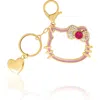 Hello Kitty Gold Outline Keychain With Red Bow And Heart In Gold