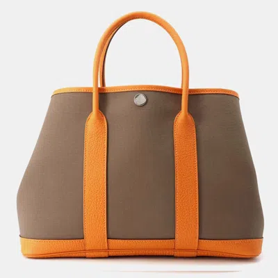 Pre-owned Hermes Etoupe/orange Toile Officier And Negonda Leather Garden Party Tpm Tote Bag