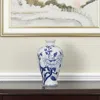 Hivvago 10" Blue And White Floral Round Porcelain Table Vase In Blue