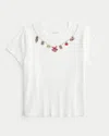 Hollister Good Luck Charm Graphic Baby Tee In White