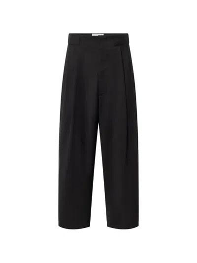 House Of The Very Islands Jonas Pleated Wool Trousers In Black