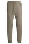 Hugo Boss Cotton-blend Tracksuit Bottoms With Mirror-effect Logo In Brown