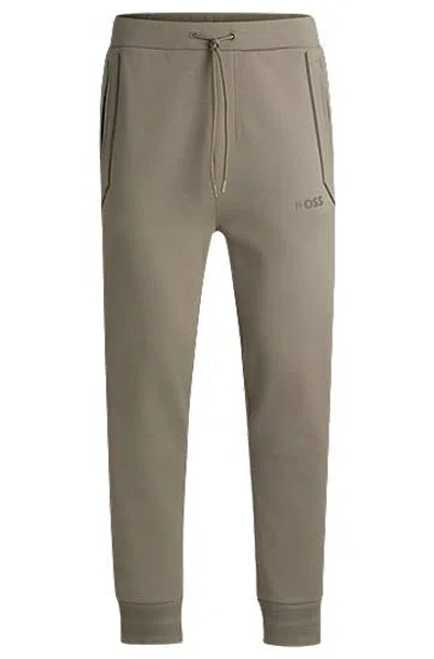 Hugo Boss Cotton-blend Tracksuit Bottoms With Mirror-effect Logo In Brown