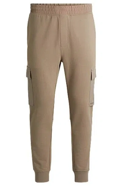 Hugo Boss Cotton-terry Tracksuit Bottoms With Cargo Pockets In Brown