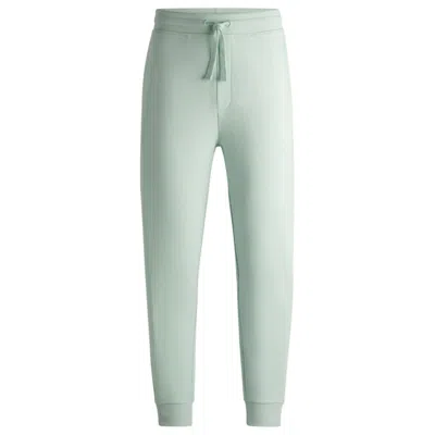 Hugo Boss Cotton-terry Tracksuit Bottoms With Logo Print In Green