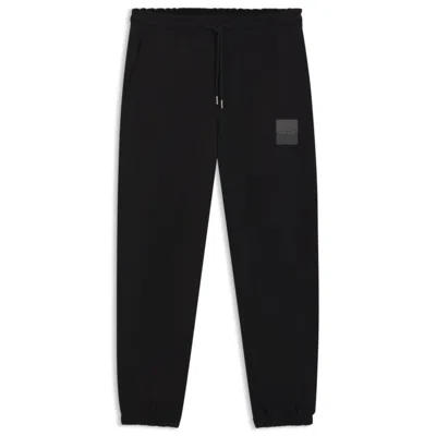 Hugo Boss Cotton-terry Tracksuit Bottoms With Split Logo In Black