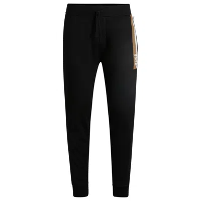 Hugo Boss Cotton-terry Tracksuit Bottoms With Stripe Print In Black
