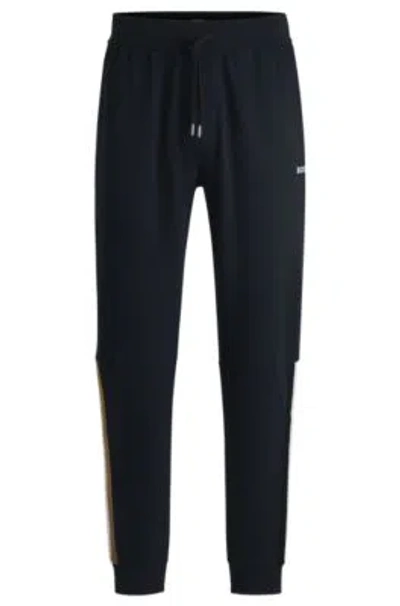 Hugo Boss Cotton-terry Tracksuit Bottoms With Tape Inserts In Dark Blue