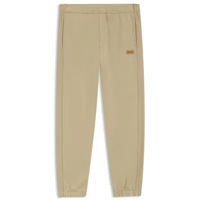 Hugo Boss Cotton-terry Sweatpants With Logo Badge In Neutral