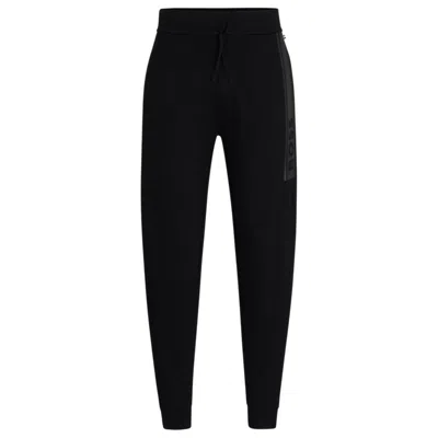 HUGO BOSS CUFFED TRACKSUIT BOTTOMS IN FRENCH TERRY WITH LOGO PRINT