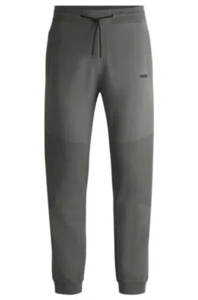 Hugo Boss Regular-fit Knitted Tracksuit Bottoms With Stripes And Branding In Light Grey