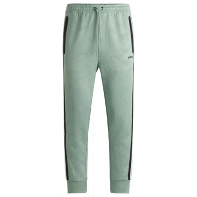 Hugo Boss Relaxed-fit Tracksuit Bottoms With Jacquard-woven Circles In Green