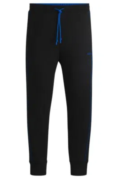 Hugo Boss Stretch-cotton Tracksuit Bottoms With Embossed Artwork In Black