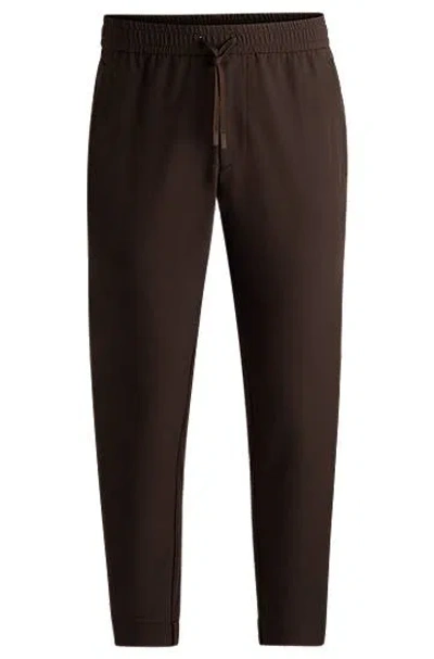 Hugo Boss Tapered-fit Chinos In Easy-iron Four-way Stretch Fabric In Brown