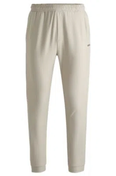 Hugo Boss Tracksuit Bottoms In Stretch Fabric With Decorative Reflective Logo In Light Beige
