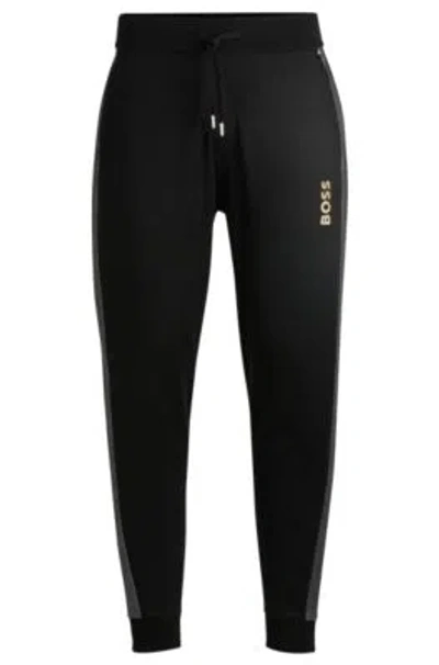 Hugo Boss Tracksuit Bottoms With Foil-print Logo In Black