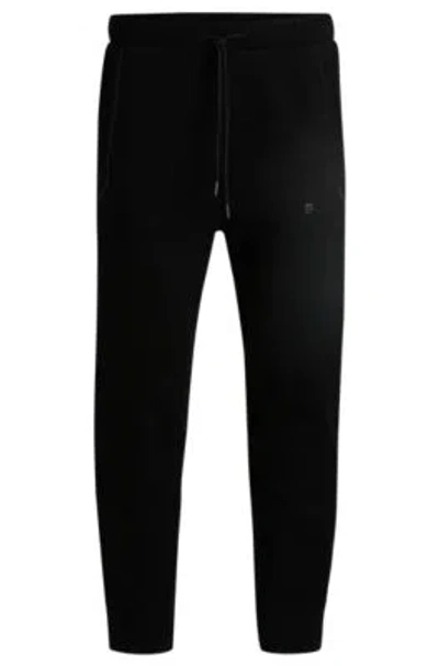 Hugo Boss Tracksuit Bottoms With Mirror-effect Logo In Black