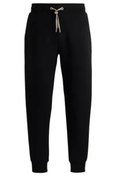 Hugo Boss Tracksuit Bottoms With Signature-stripe Cords In Black