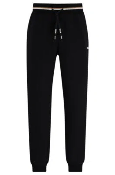 Hugo Boss Tracksuit Bottoms With Stripes And Logos In Black
