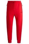 Hugo Boss Tracksuit Bottoms With Tape Inserts In Light Red