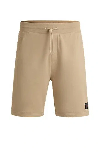 Hugo Boss Cotton-terry Relaxed-fit Shorts With Logo Trim In Beige